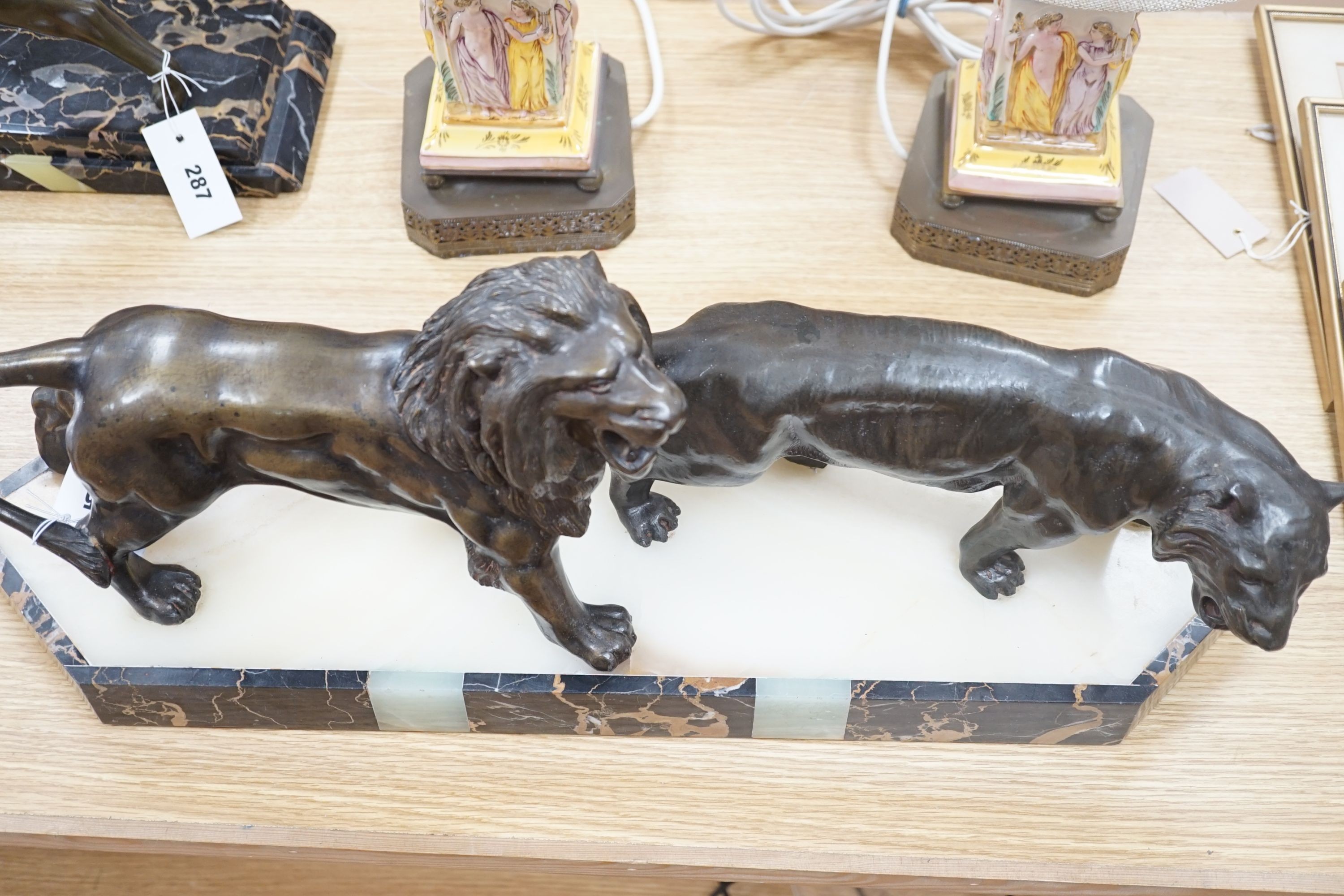 An Art Deco bronzed metal, marble and onyx group of lion and lioness, signed Benaca, 67cm